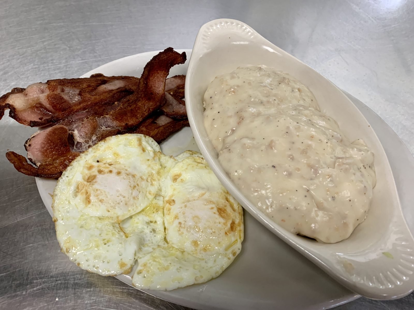 Bacon, eggs and biscuits with country sausage gravy